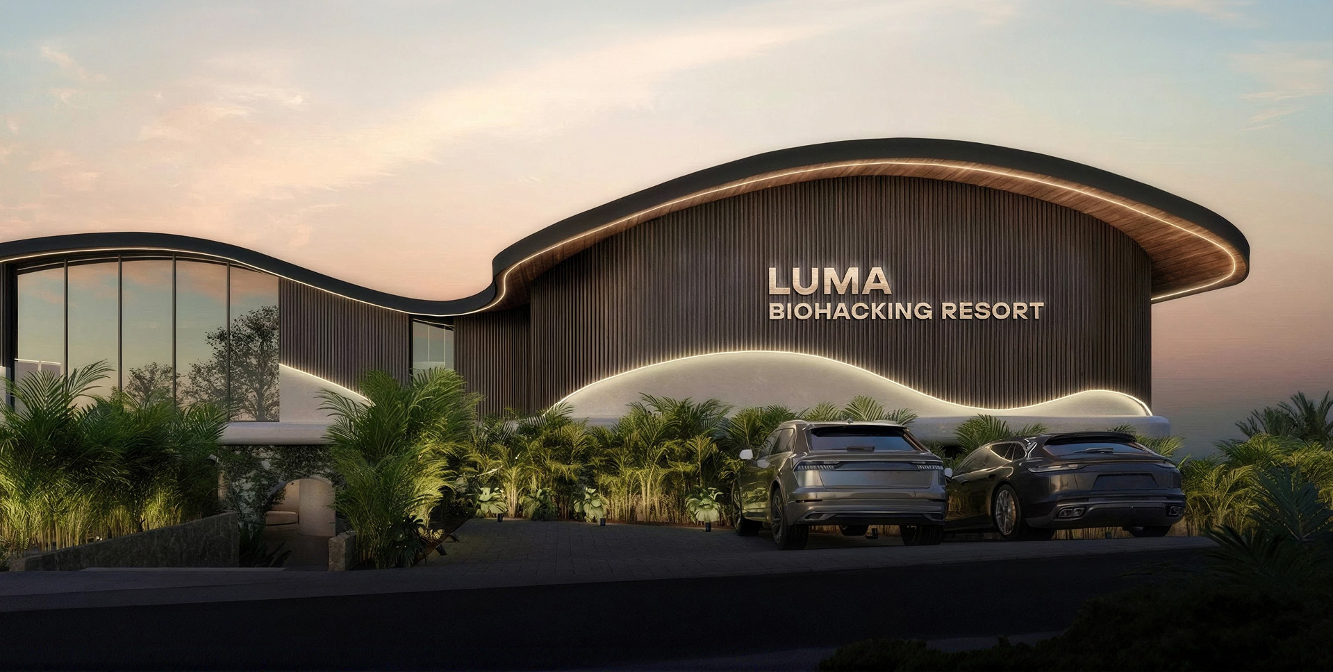 Luma Biohacking Resort exterior at dusk — wavy timber roofline, warm façade lighting, tropical greenery