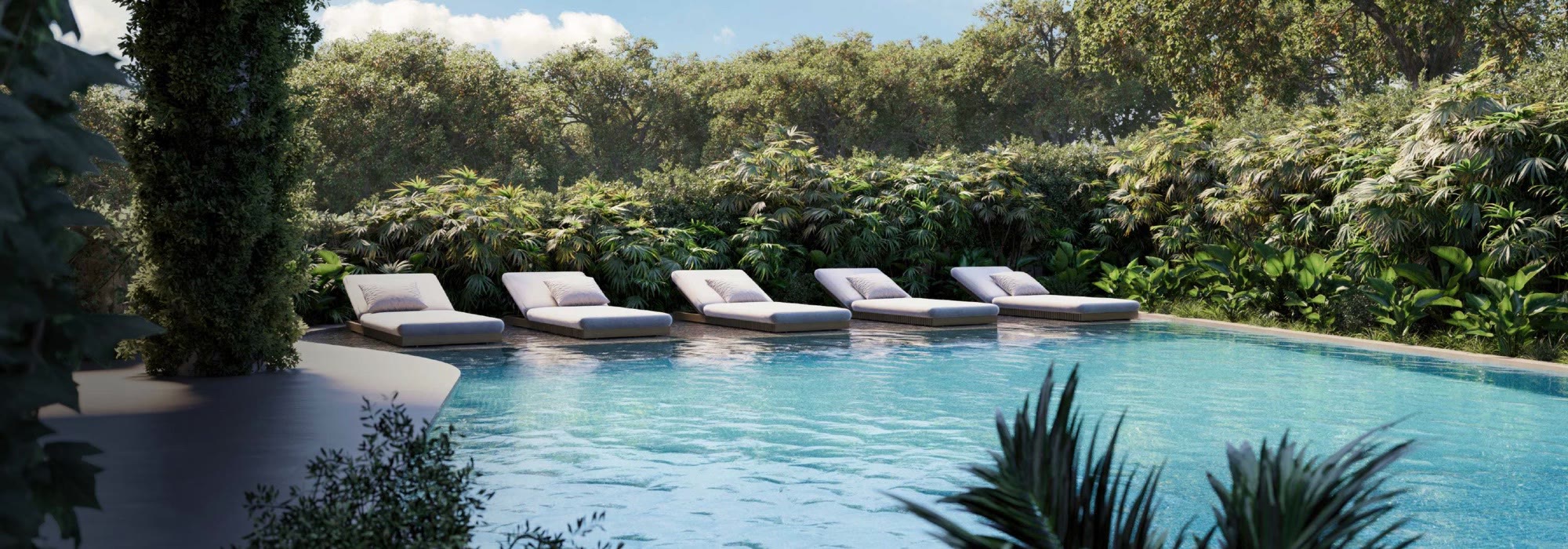 Thermal pool with loungers set in the water, surrounded by jungle